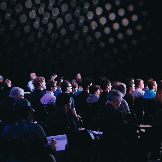 A photo showing the audience at a conference. 